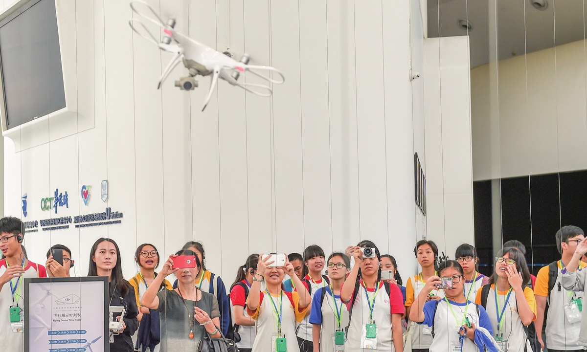 Students and teachers from Hong Kong visit a DJI flagship shop in Shenzhen, South China's Guangdong Province during a tour to witness the achievements of China's reform and opening-up in June 2018. Photo: Xinhua
